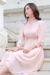Silk midi dress with ruffle neckline and smocked cuffs for a romantic vintage-inspired look